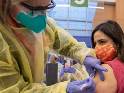 woman getting a vaccine on her arm