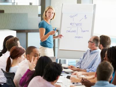 woman teaching a group of employees