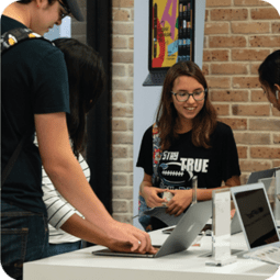 Students looking at laptops in the campus bookstore