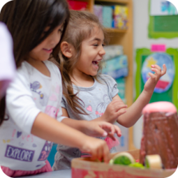 Two female children learning thru hands on activites