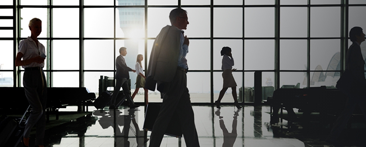 Groups of business people walking through the airport with their luggages