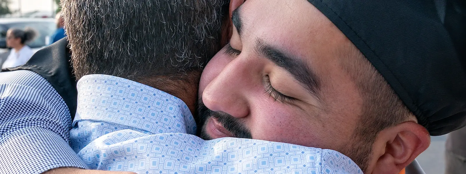 CECS graduate hugging his father after Commemcement