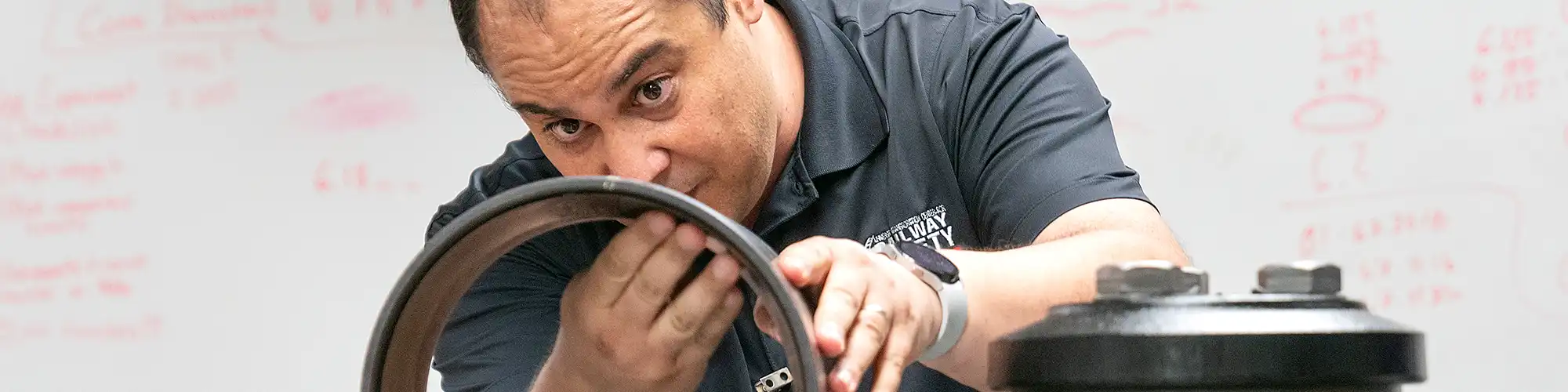 Professor showing a cylinder to a class.