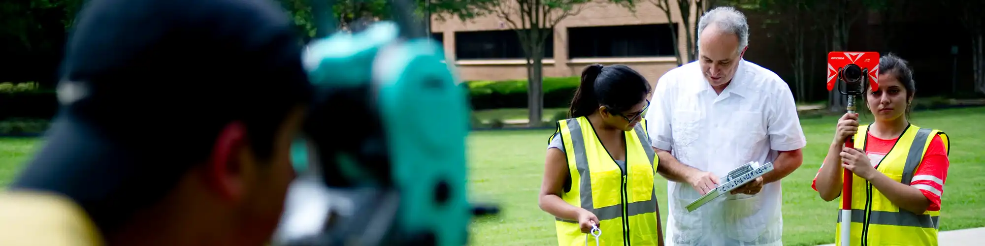 Instructor teaching students how to survey.