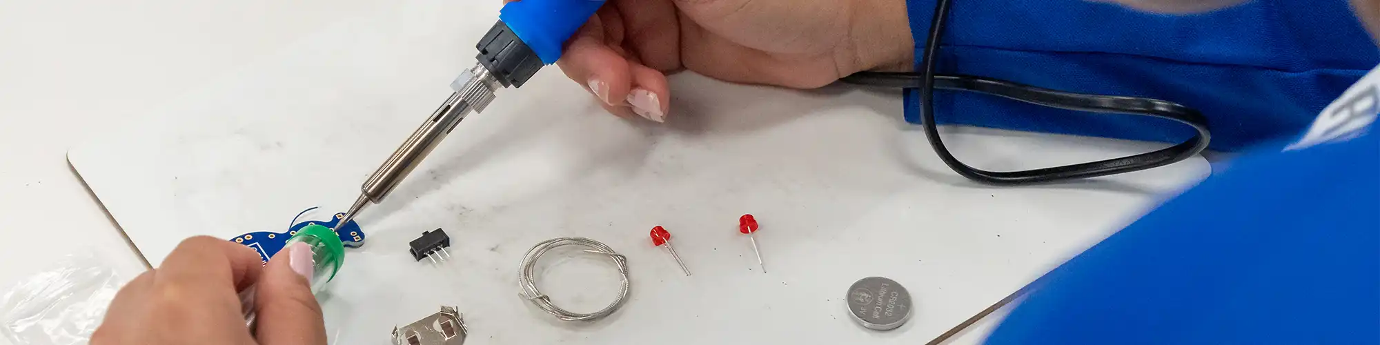 Student using a soldering tool
