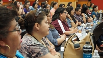 Crowd of people looking at presentation