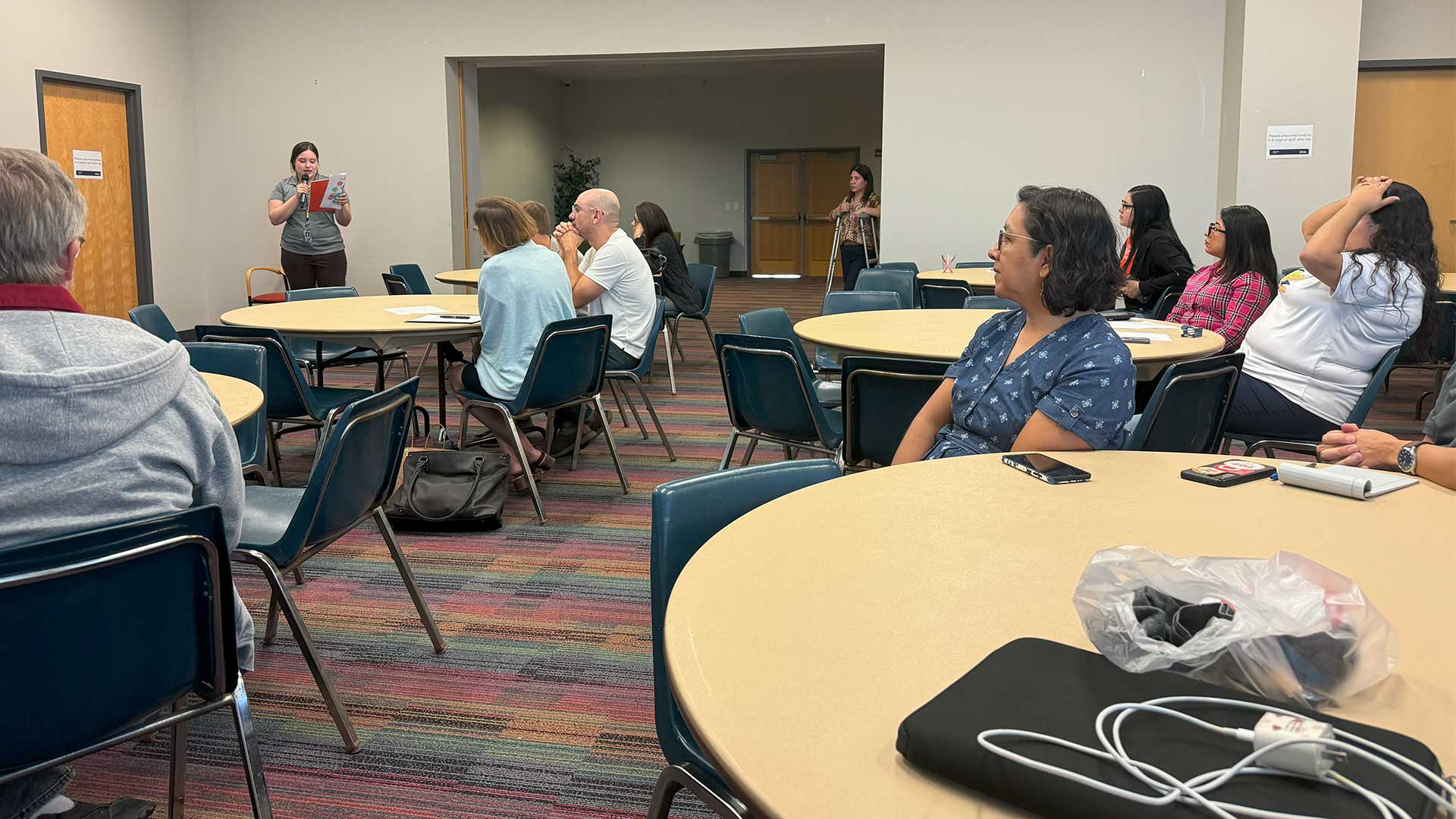 Center for Bilingual Studies staff in a conference hearing a speaker.