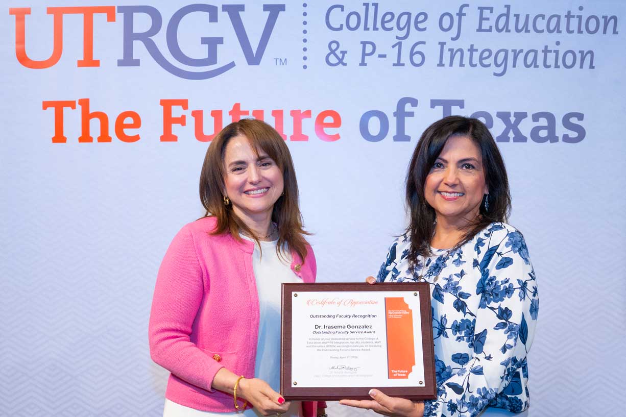 Dr. Irasema Gonzalez receiving the Outstanding Faculty Service Award from Dr. Alma D. Rodriguez
