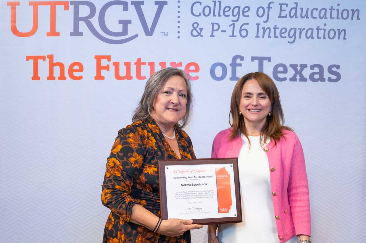 Ms. Norma Sepulveda receiving the Outstanding Staff Excellence Award from Dr. Alma D. Rodriguez