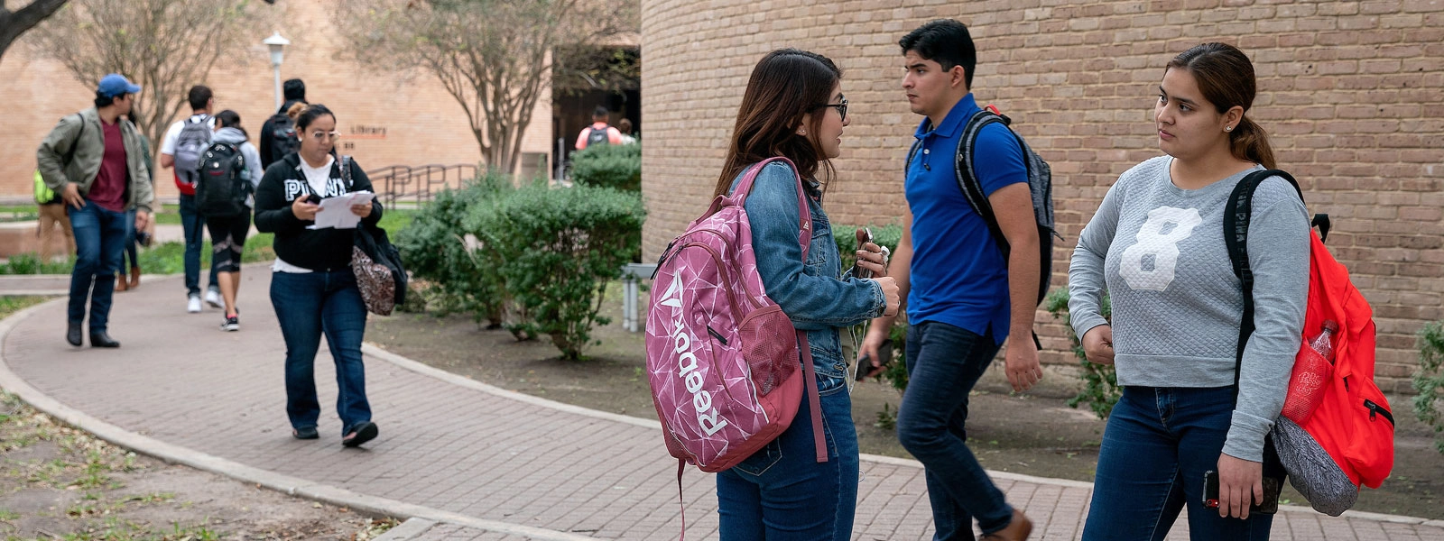 Students communicating in the hallway of campus.