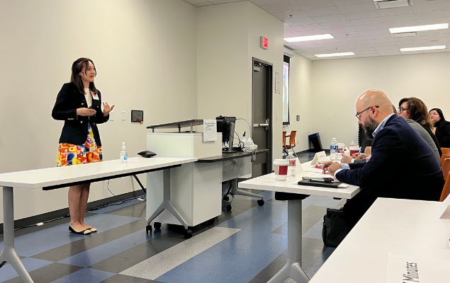 A competitor of the 2022 Rafael Munguia Business Plan Competition pitches her company, Modern Day Hippy, to an audience of judges and spectators.