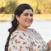 employee smiling with blurry outside background