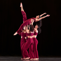 modern dancers on stage wearing red outfits