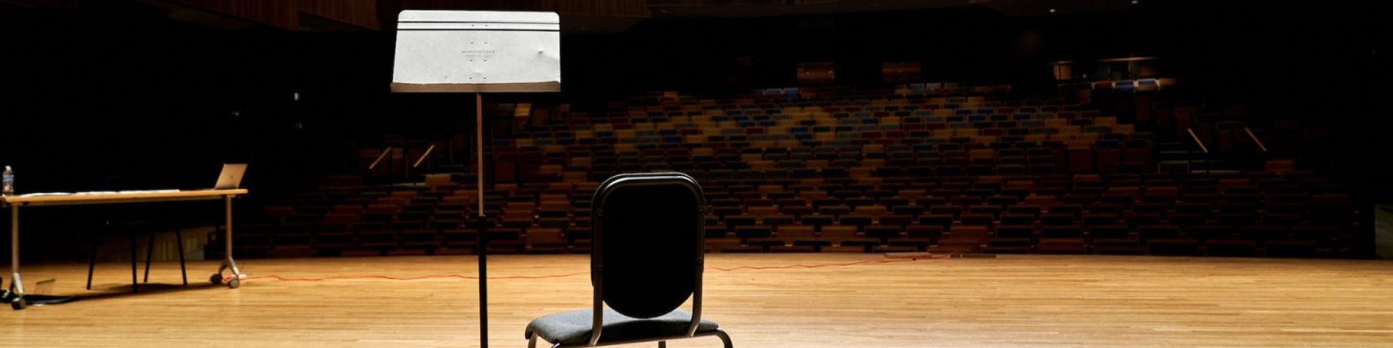 A chair inside of the empty performing arts complex