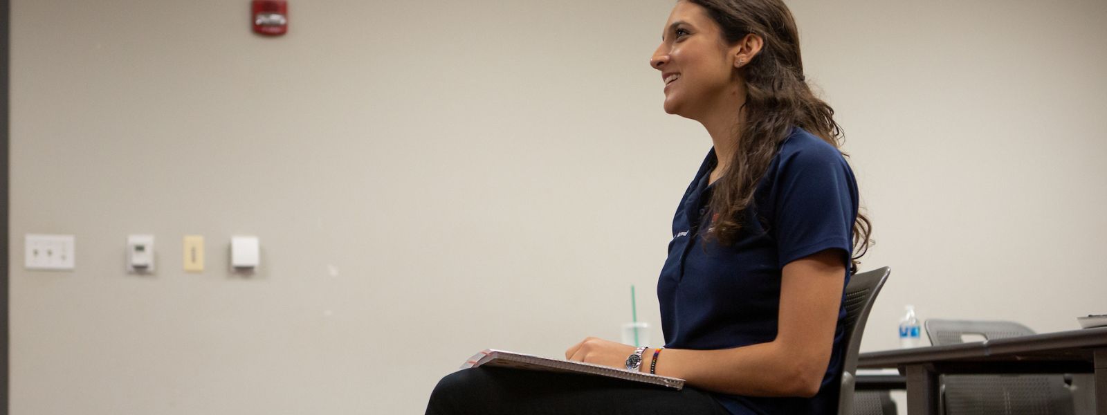 Smiling student sitting in class.