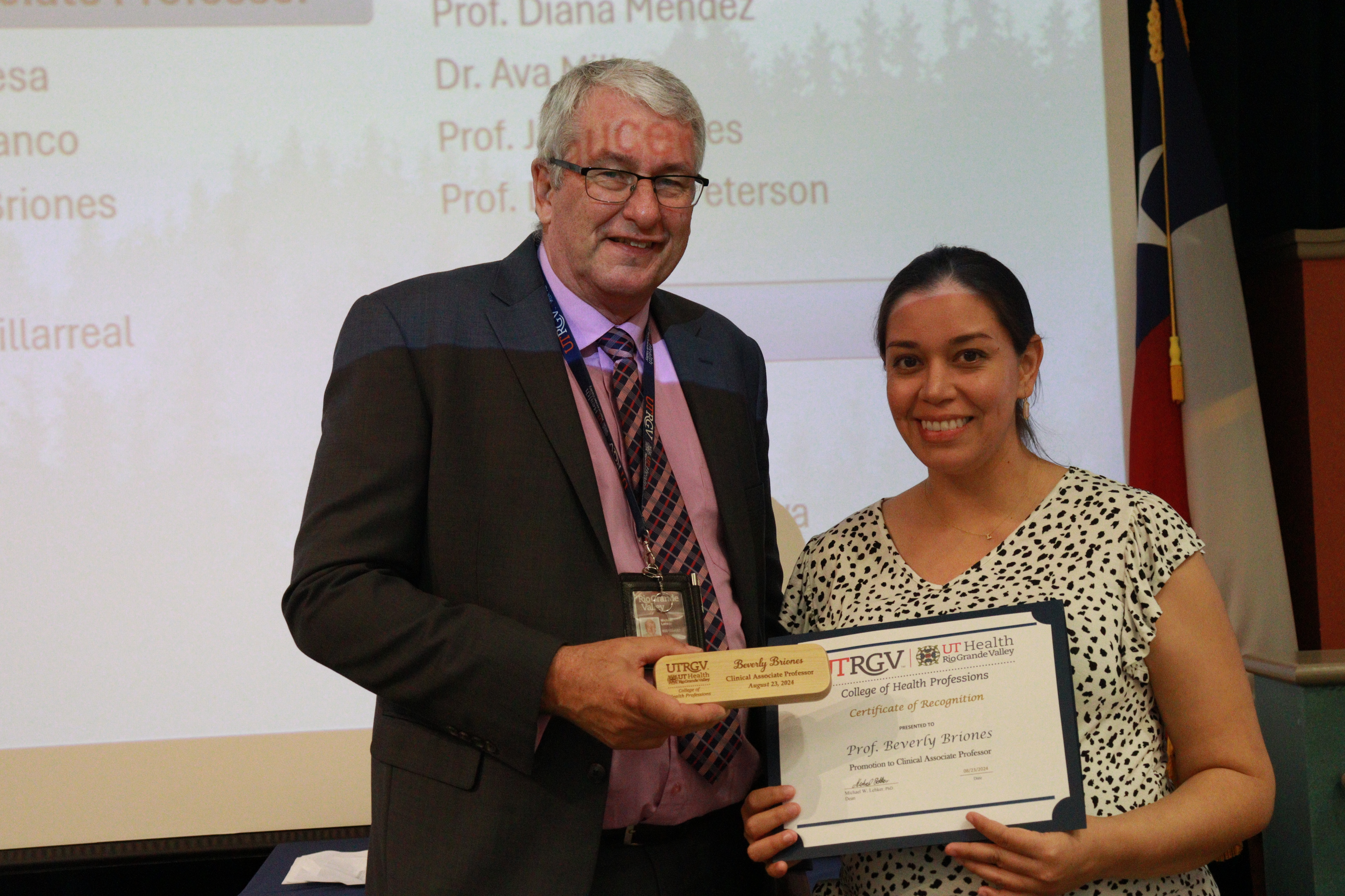 Faculty receiving award from dean.