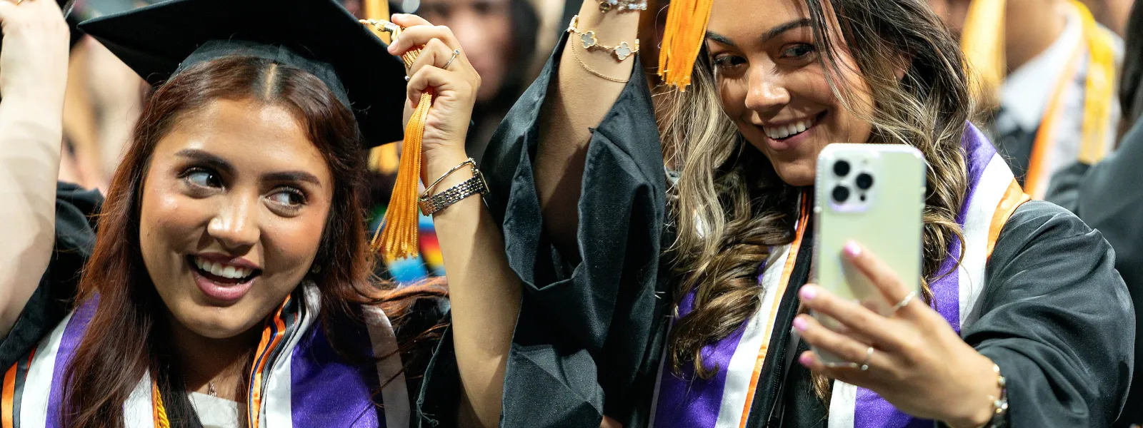 graduates taking selfie at commencement