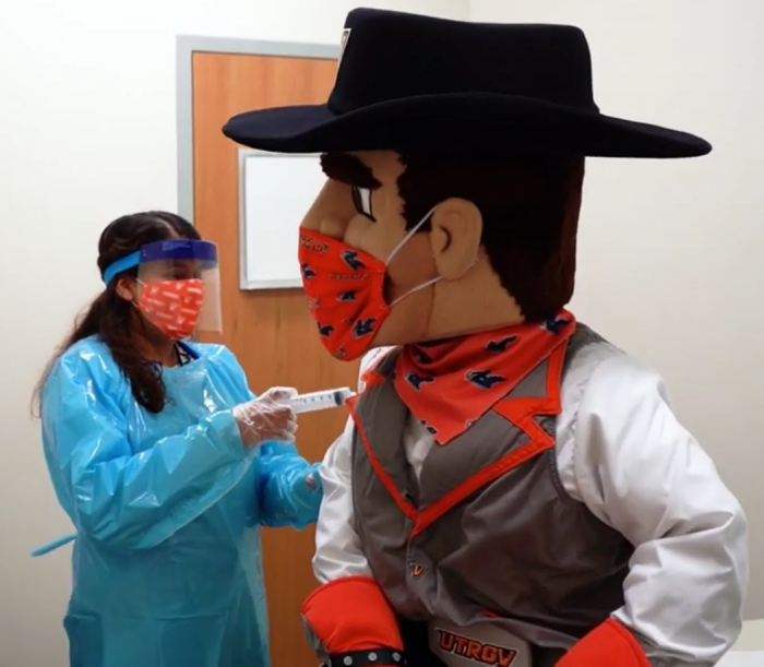 Vaquero mascot getting the COVID-19 vaccine.