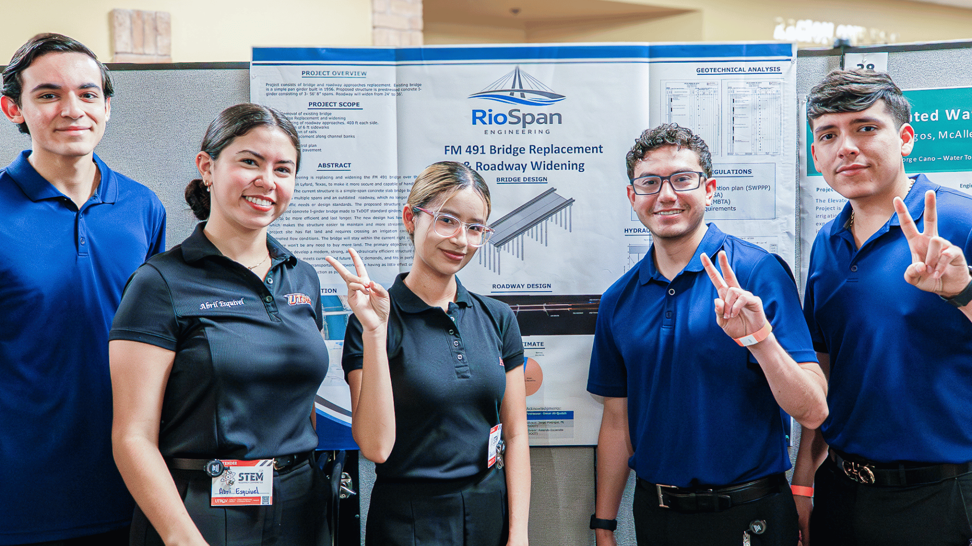 Five engineering students posing for a photo in front of their research at the 2026 STEM Research Conference