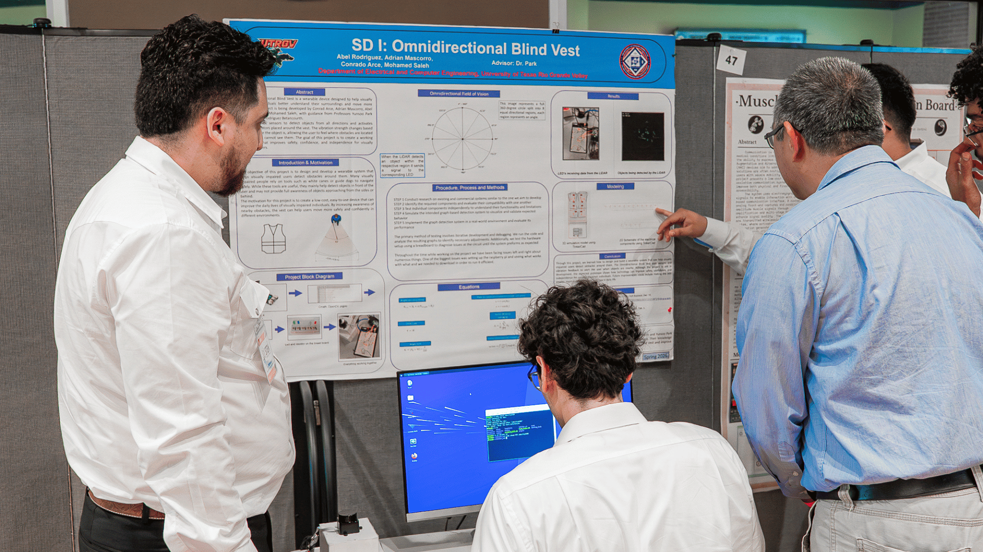 Photo of presenters engaged in discussion of their research at the 2026 STEM Research Conference