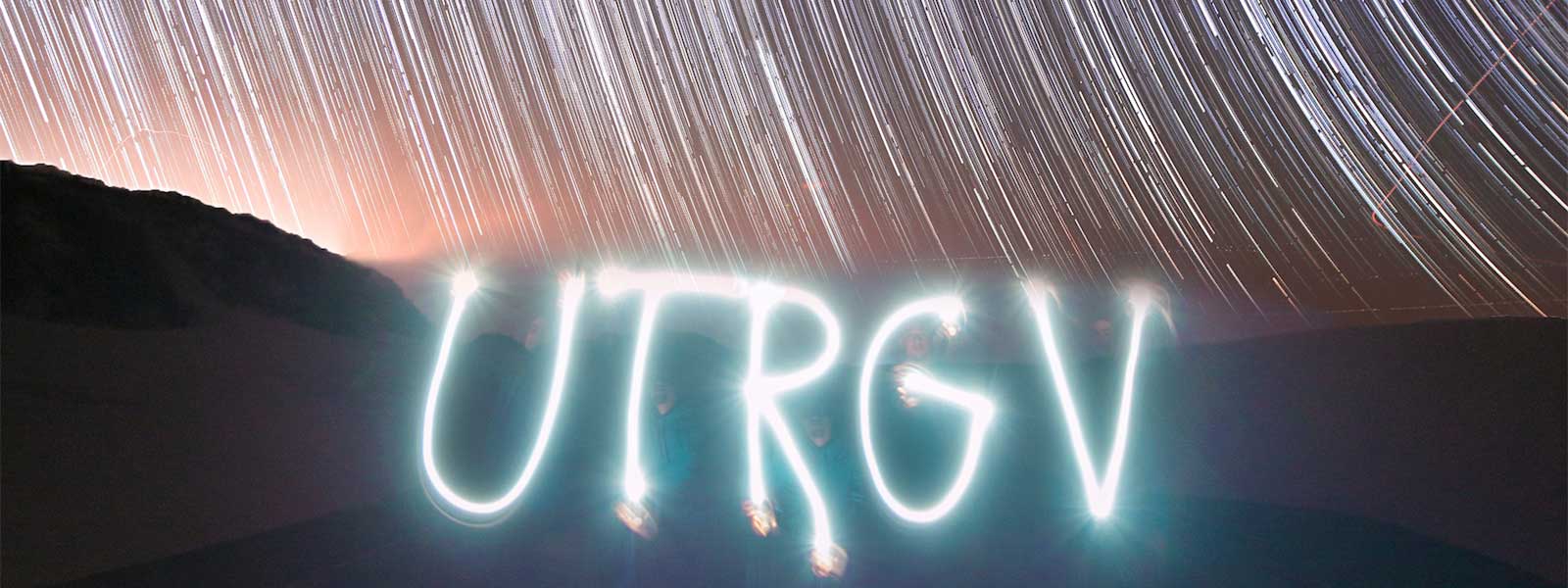 stars in the background with the UTRGV letters formed from light sources