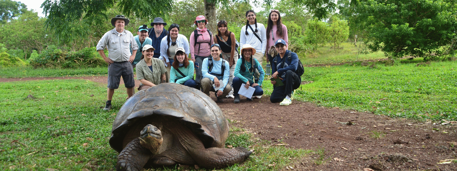 Students posing for a wide group picture at Galapagos Islands