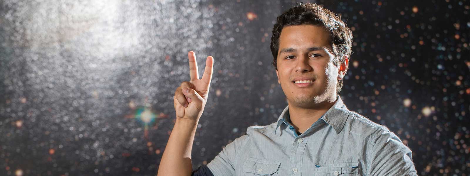 student showing his V's Up! hand sign