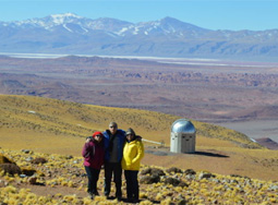 research scientists outside the observatory