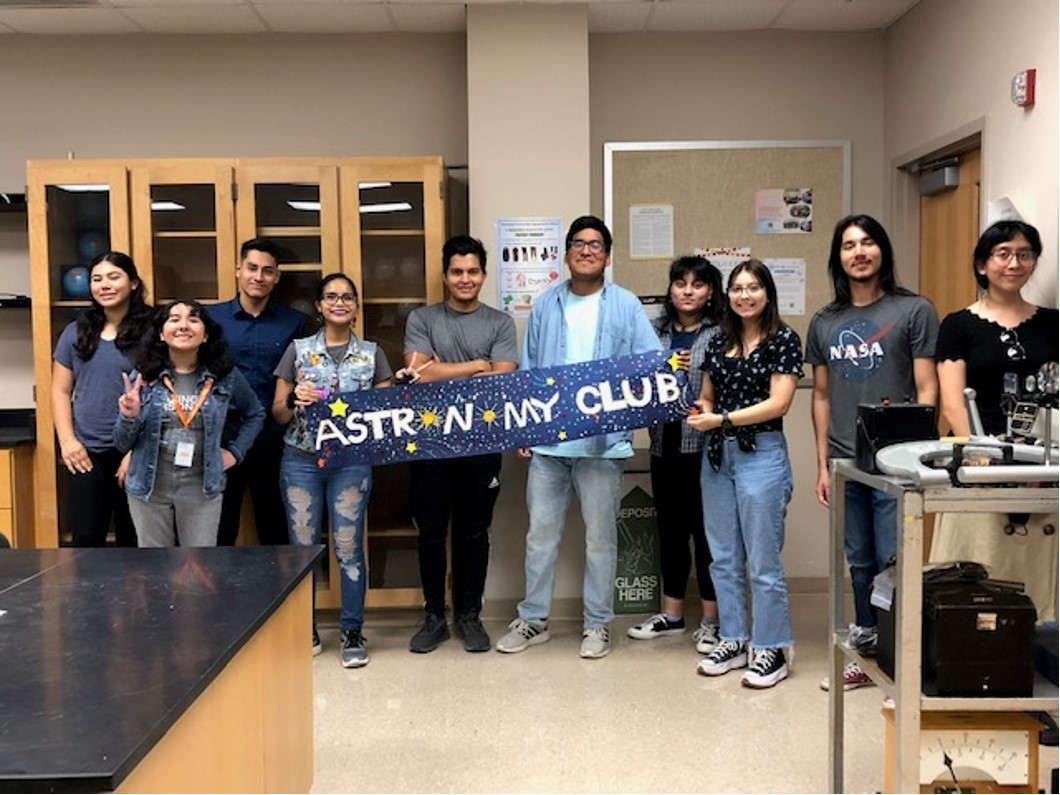 Astronomy Club members holding a banner of the club