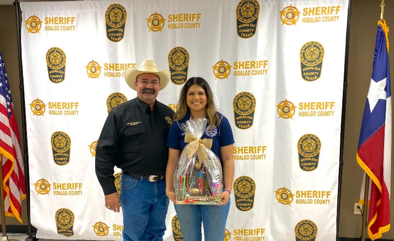 Student holding basket right next to sheriff