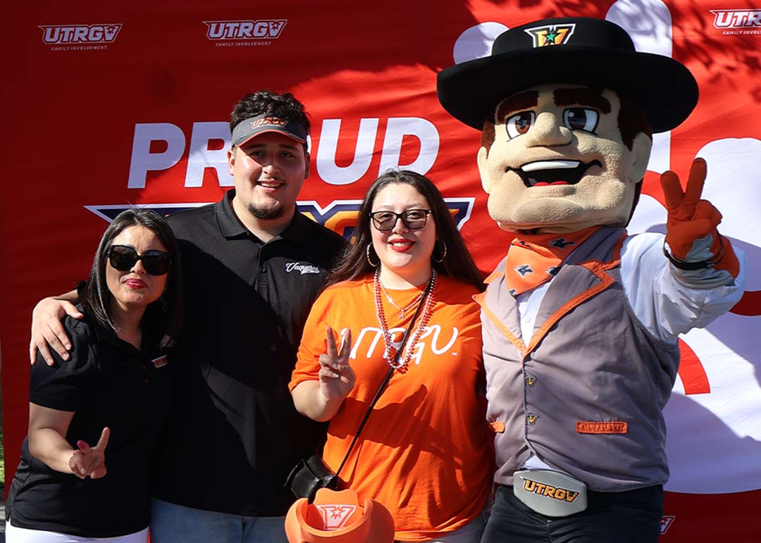Family posing with Victory the Vaquero at the awarding of Family of the Year.