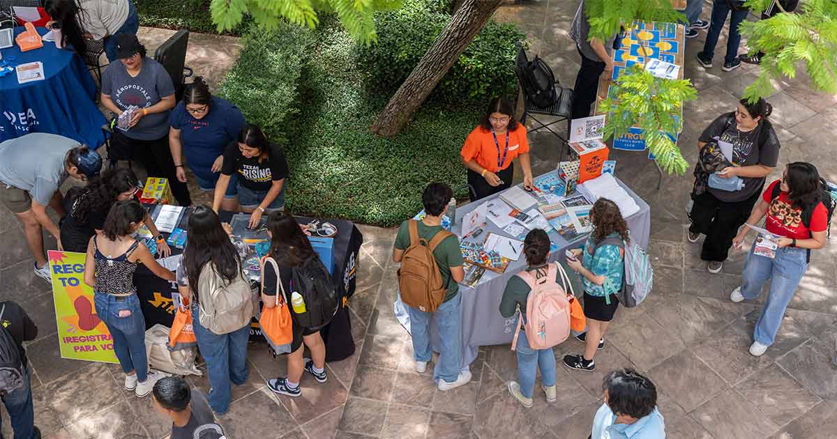 Students at a get involved fair tabling and asking questions.