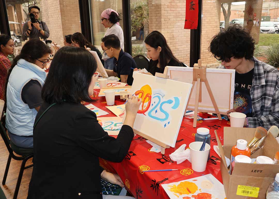 Students painting on a canvas