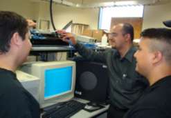 Graduate students working in networking laboratory
