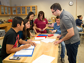 Five students and a professor doing a lab experiment