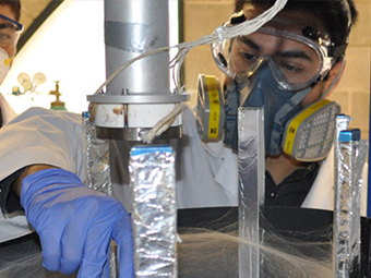 Student with mask doing materials experiment