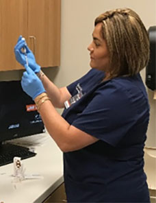 UTRGV Nurse handling a syringe.