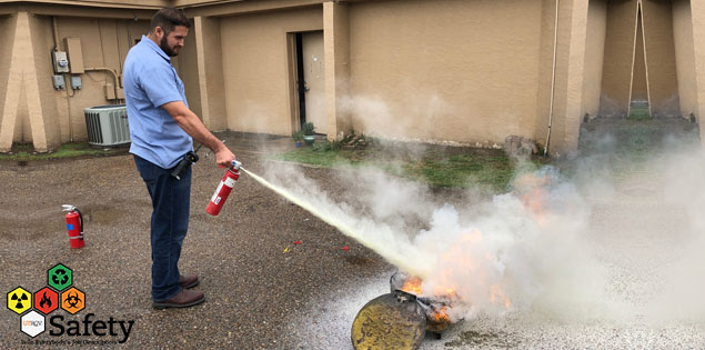 UTRGV Staff putting off a fire using a fire extinguisher.