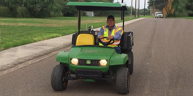 UTRGV employee driving a utility vehicle.