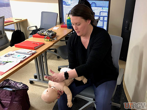 Practicing back blows on a conscious choking infant, First Aid training, December 14, 2018.