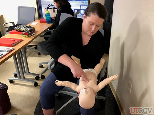 Practicing chest thrusts on a conscious choking infant, December 14, 2018.
