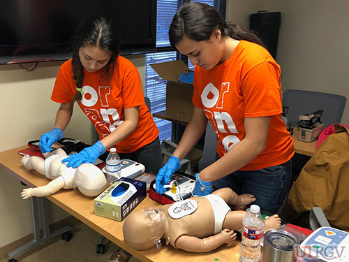 Child Development Center employees practice using an AED on an infant manikin, November 30, 2018.