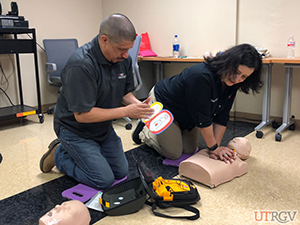 RGV CPR Instructor teams up with UTRGV shuttle driver to use the AED as quickly as possible.