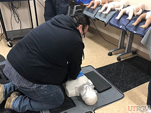 Performing chest compressions on an adult manikin, November 28, 2018.