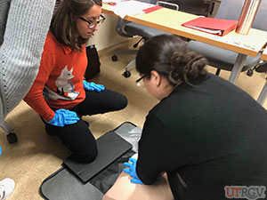 Practicing hand placement for compressions on an adult manikin, November 28, 2018.