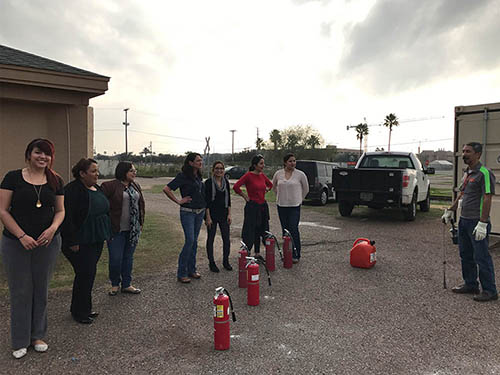 Saul Jauregui is getting ready to light the fire for an excited group participating in Evacuation Assistant / Fire Extinguisher Training.