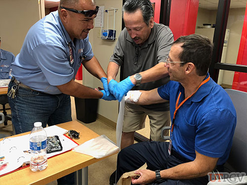 Campus Facilities and University Recreation staff practice controlling severe bleeding during First Aid/CPR/AED Training, Sept 19, 2018
