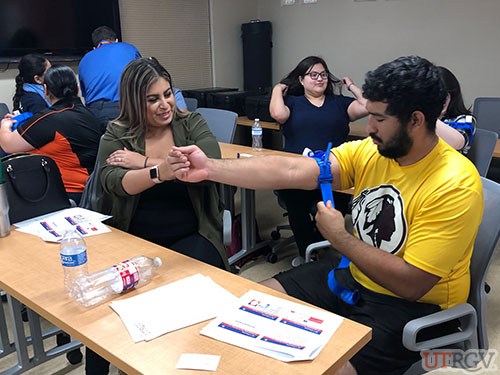 Applying a tourniquet, Stop the Bleed Training.