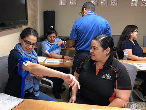 Applying a tourniquet, Stop the Bleed Training.