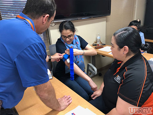 Applying a tourniquet, Stop the Bleed Training.